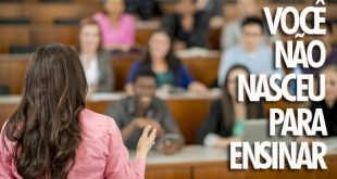 A multi-ethnic group of college students are sitting taking notes in a lecture hall - an instructor is standing up front leading the class.